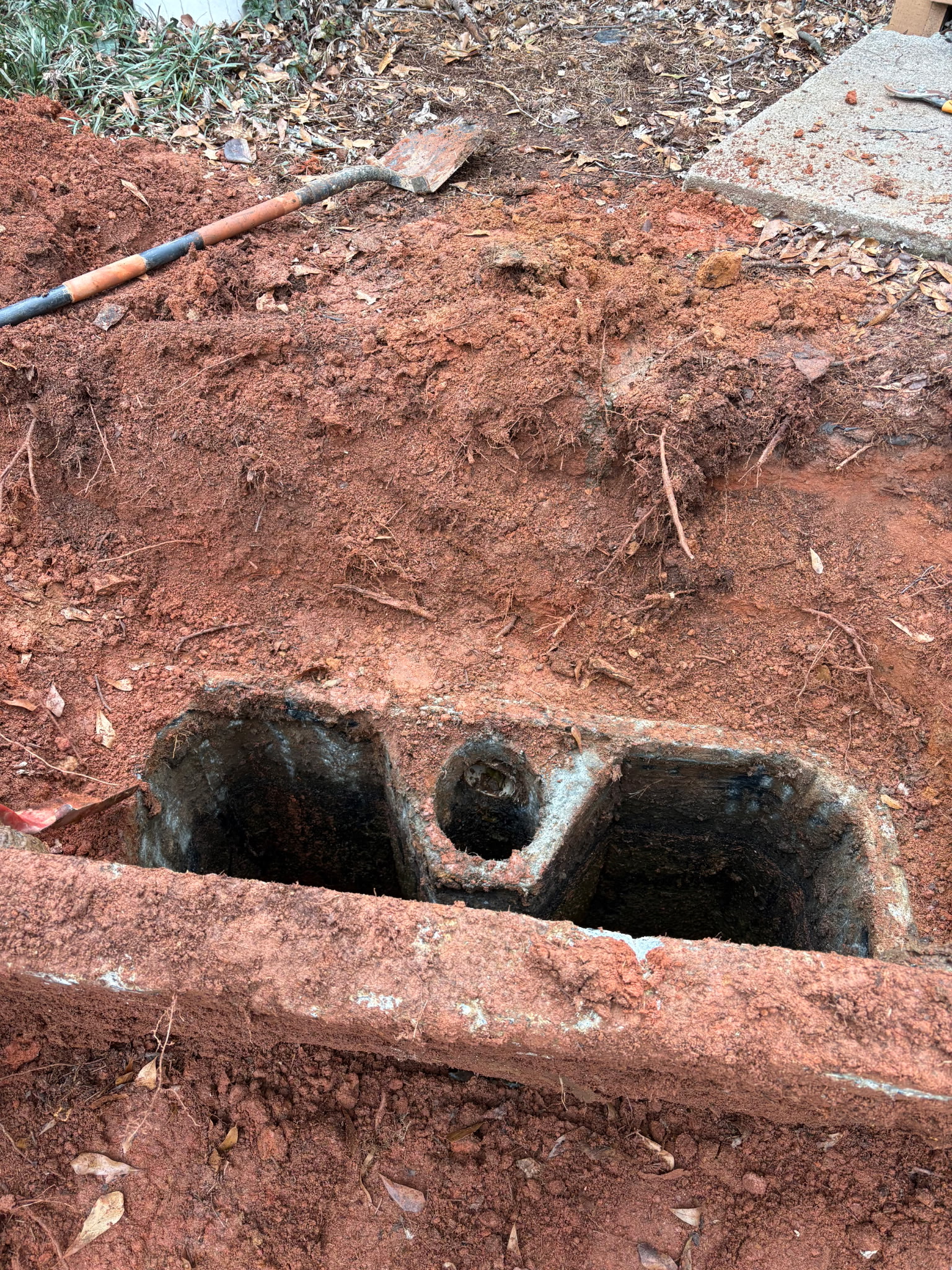 Old two-compartment concrete septic tank interior uncovered during repair by Sanders Septic Loganville GA