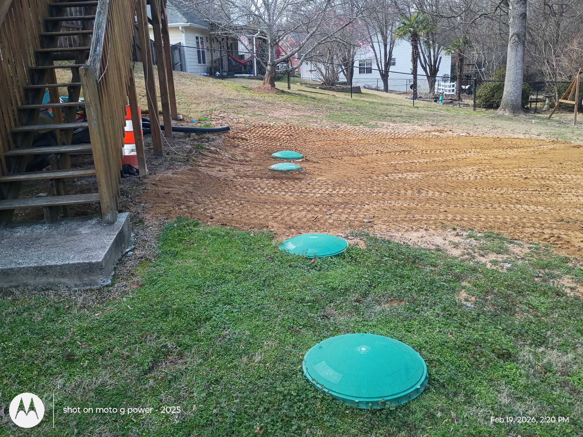 Completed septic system installation by Sanders Septic LLC showing green access lids installed in Loganville Georgia yard