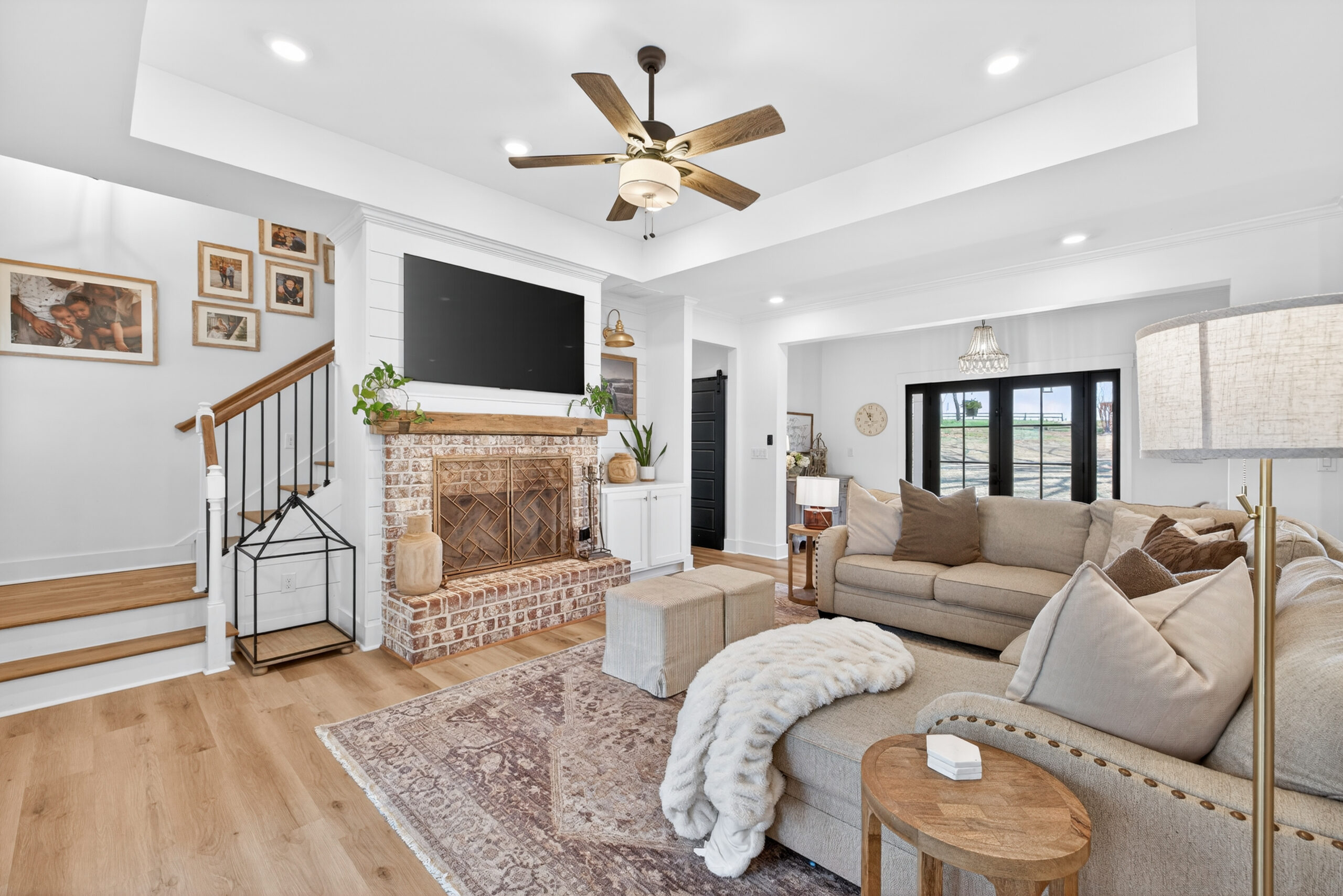 Great room at 4746 Bentley Road Monroe GA — floor-to-ceiling brick fireplace with reclaimed timber mantel and custom shiplap accents