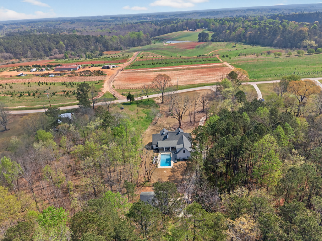 Aerial wide view of 4746 Bentley Road Monroe GA and surrounding Walton County landscape — private wooded acreage with neighboring tree farm